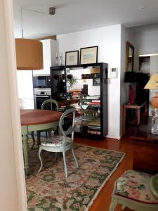 a living room with a table and a dining room at Casa de Leça in Leça da Palmeira