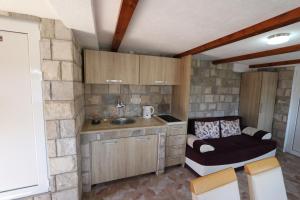 a small kitchen with a sink and a counter at Apartments Woodstock 4 in Buljarica