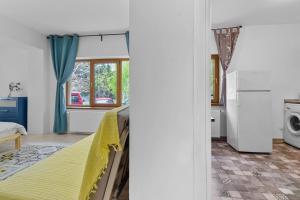 a bedroom with a bed and a kitchen at homestay in Otopeni