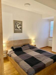 a bedroom with a large bed in a room at Bright Scandi Apartment in Skopje