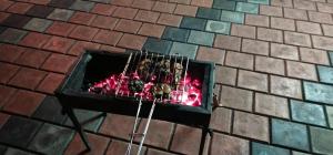 a brick fireplace with a fire in it at Cassa Cottage Munnar in Kallar Vattiyar