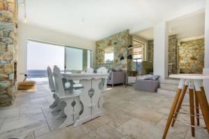 a large living room with a stone wall at Villa Aeonia in Karistos
