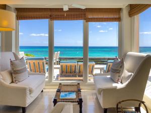 a living room with a view of the ocean at Palm Hill House home in Rock Sound