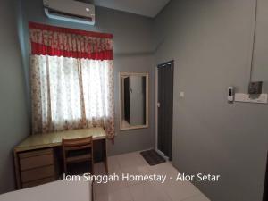 โทรทัศน์และ/หรือระบบความบันเทิงของ Jom Singgah Homestay - Alor Setar