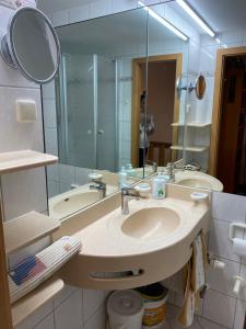 een badkamer met een wastafel en een spiegel bij Ferienwohnung Familienglück in Sankt Englmar