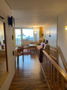 a living room with a stairway leading to a living room at Ferienwohnung Familienglück in Sankt Englmar