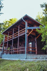 a large wooden building with a roof at Etno domaćinstvo Milenković in Despotovac