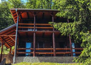 a log cabin in the woods with trees at Etno domaćinstvo Milenković in Despotovac