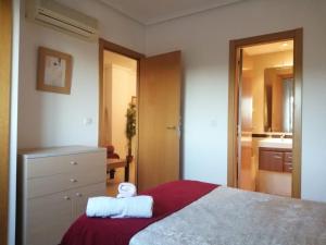a bedroom with a large bed and a bathroom at Magic World Aguamarina in Oropesa del Mar +11 photos