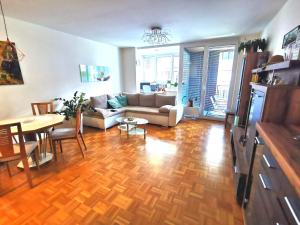 a living room with a couch and a table at Cozy apartment Ljubljana with free parking and balcony in Ljubljana