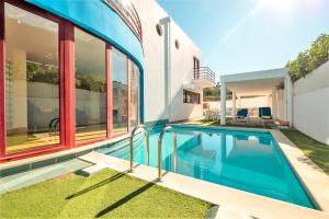 a house with a swimming pool and windows at Villa Acapulco by Algarve Vacation in Albufeira