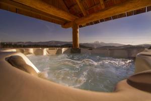 a hot tub with a view of the mountains at Osada Beskidzka in Zawoja