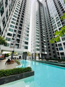 a swimming pool in front of two tall buildings at The base Central 1006 by Numam in Pattaya