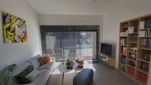 a living room with a couch and a table at Villa HOME HOLIDAY à Cala Rossa in Lecci