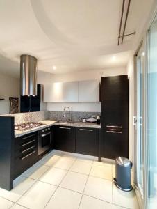 a kitchen with black cabinets and a sink at VistaMare Bluemar - The Art of the Sea - 105mq in Cattolica