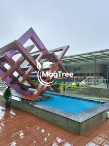 a swimming pool in a mall with a micture sign at MagTree Genting Highlands in Genting Highlands