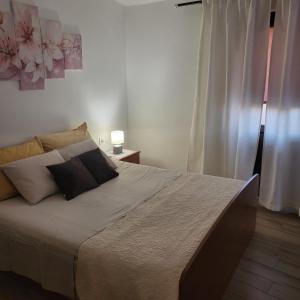 a bedroom with a large bed with a window at Licul Apartment in Rovinj