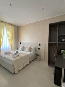 a bedroom with a large white bed and a window at Affittacamere Flori in La Spezia