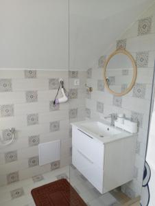 a bathroom with a white sink and a mirror at Casa Popa in Gura Humorului