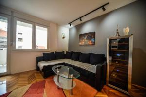 a living room with a couch and a glass table at goltepirot in Pirot