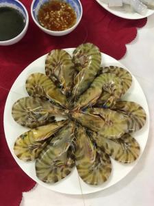 a plate of food on a table with a plate of food at Bảo Ngọc Cô Tô hotel in Đảo Cô Tô