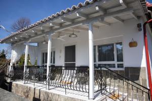 a house with a pergola on the front porch at SUN'S HOUSE in Asprovalta