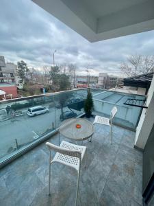 a balcony with two chairs and a table on a roof at Dany Studio in Eforie Nord