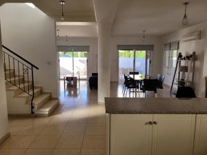 a kitchen and living room with a staircase and a dining room at ELeAN VILLA in Paphos City