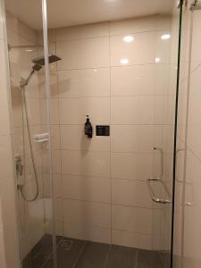 a shower with a glass door in a bathroom at MagTree Genting Highlands in Genting Highlands