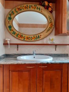 bagno con lavandino e specchio di La Casa Più Sù a Manziana