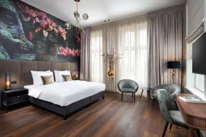 - une chambre avec un grand lit blanc et un bureau dans l'établissement Boutique Hotel Brasa Beemster, à Middenbeemster