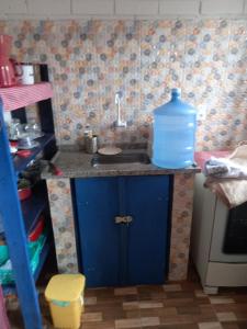 a kitchen with a sink with a bottle of water on it at Nino's in Niterói