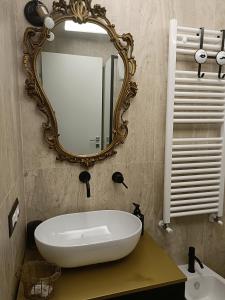 a bathroom with a white sink and a mirror at Le finestre sul lago in Piediluco +34 photos