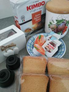 una mesa con un plato de pan y una caja de comida en A due passi dalla ciclabile, en Calalzo