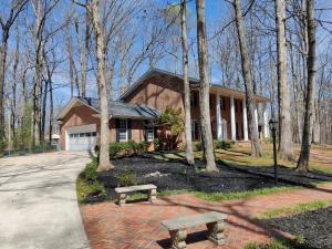 a house with a bench in front of it at Living Easley Manor - With Amazing Hot Tub! in Easley