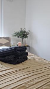 a pile of blankets sitting on top of a bed at Apartament Czechowska Comfort in Lublin