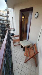 a balcony with two benches and a table on a building at Princess and Prince Apartman in Budapest