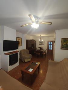 ein Wohnzimmer mit einem Sofa und einem Tisch in der Unterkunft CASA RURAL FERRETE in Cañete la Real