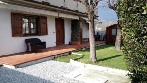 a porch of a house with a bench in the yard at Verdazzurro in Camaiore