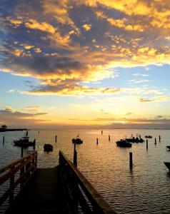 a dock with boats in the water at sunset at Civico 13 in Scardovari