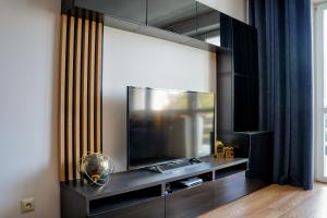 a living room with a large flat screen tv at Apartament 914 in Wisła