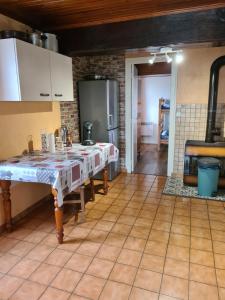 a kitchen with a table in the middle of a room at commealaferme71.vacances in Montret