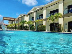 a large swimming pool in front of a building at Eagle Beach Aruba Breeze Condominium Lime in Palm-Eagle Beach