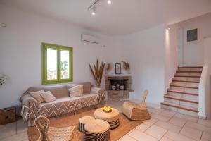 a living room with a couch and a table at Ventu Paros Villa - Pet Friendly in Márpissa