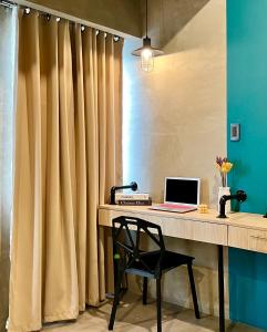 an office with a desk with a laptop and a chair at Cozy Spacious Hotel Type Condo with PS5 Smart TV and WiFi in Manila