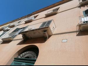 a tall building with two windows and a balcony at L'amuri du mare in Trapani