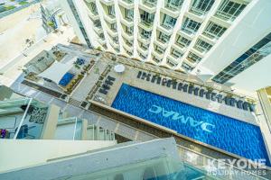 a view from above of a building with a swimming pool at Modish Studio in Damac Hills 2 in Dubai