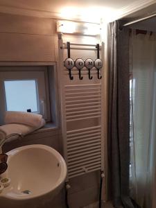 a bathroom with a white sink and a shower at Thomais Guesthouse in Kavala