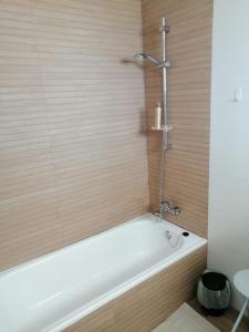 a bath tub with a shower in a bathroom at Casares Cozy Apartment in Casares