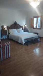 a bedroom with a large bed and a wooden floor at Casa Agapito Marazuela in Segovia